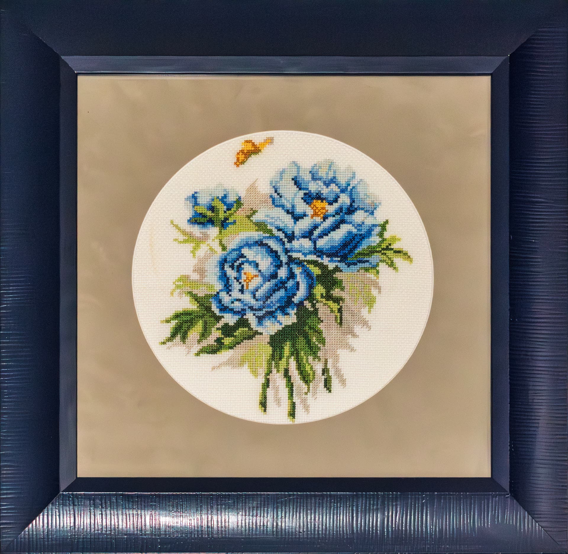 Embroidered blue peonies in a circle, navy lacquered frame