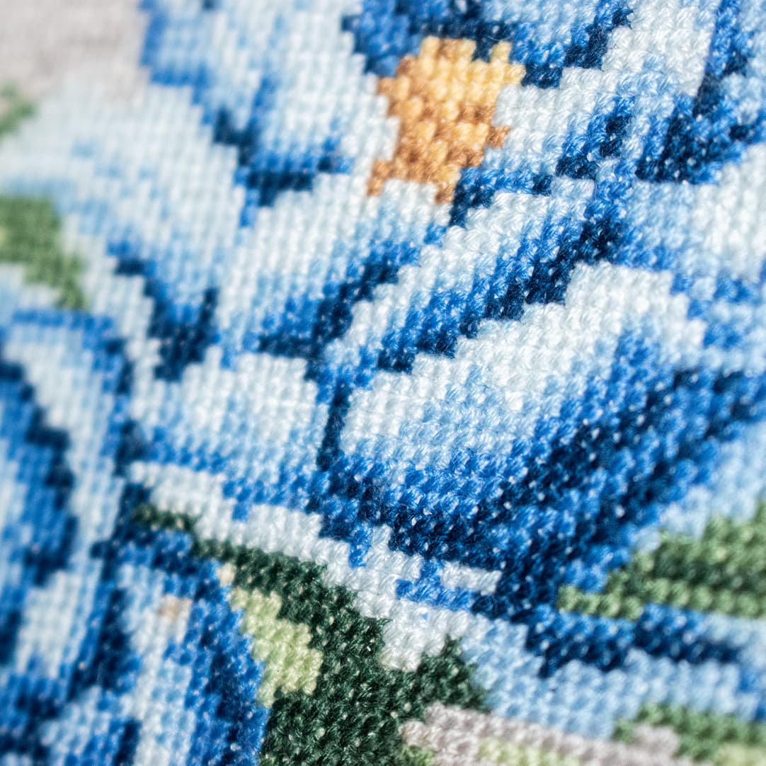 Close-up fragment of “Blue Peonies”: the texture of hand-stitched crosses