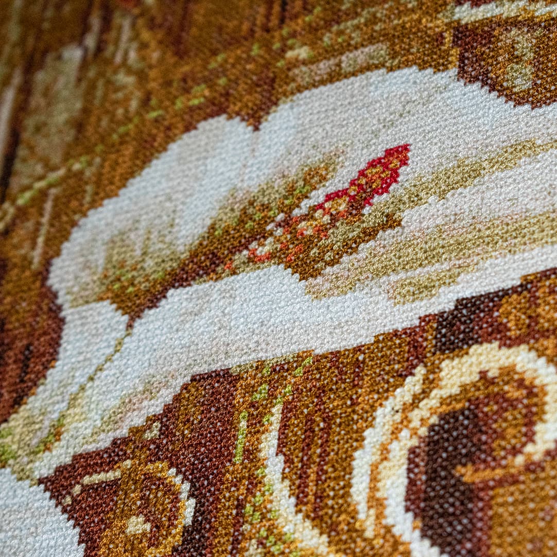 Close-up fragment of “Calla Lilies”: the texture of hand-stitched crosses