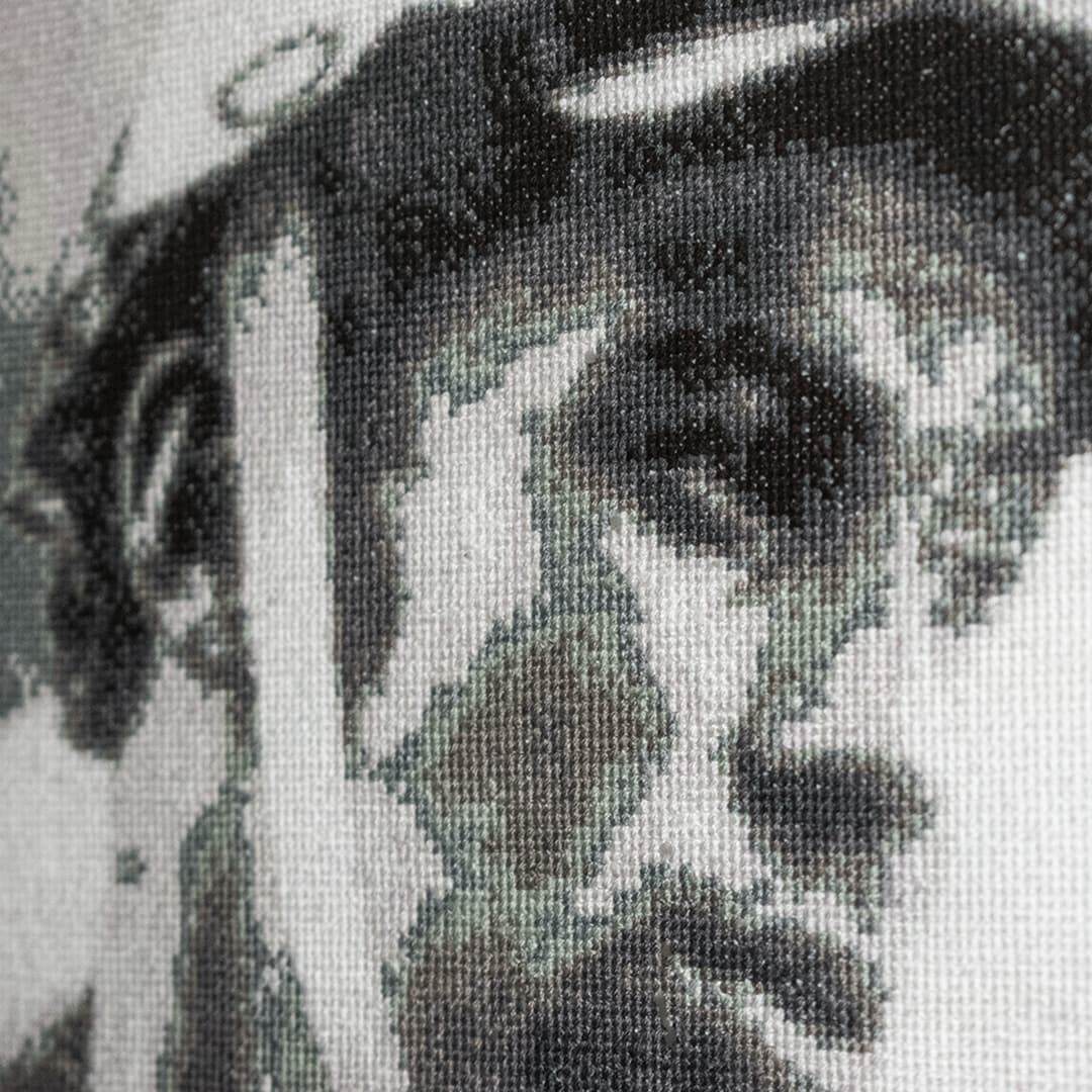 Close-up fragment of “Grandfather”: the texture of hand-stitched crosses