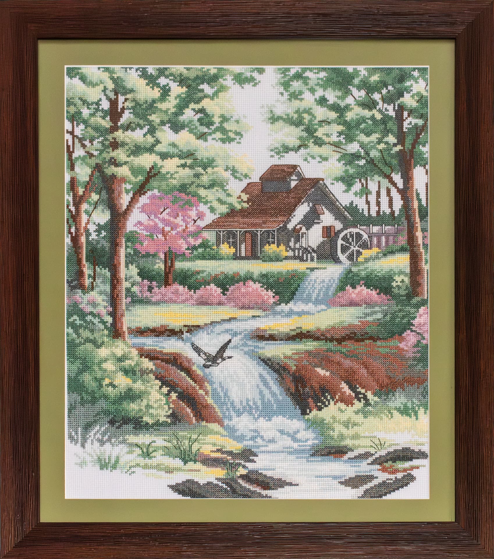 Embroidered cottage with a watermill by a stream, walnut frame