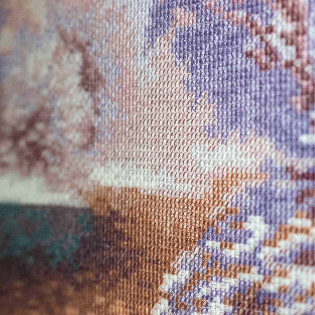 Close-up fragment of “Winter River”: the texture of hand-stitched crosses
